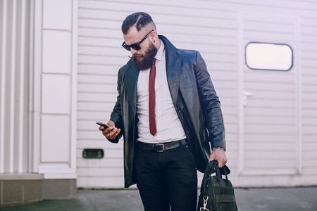 business man checking objects in glasses shirtの写真素材