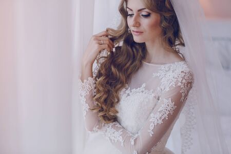 beautiful blonde bride enjoys her wedding day in the summerの写真素材