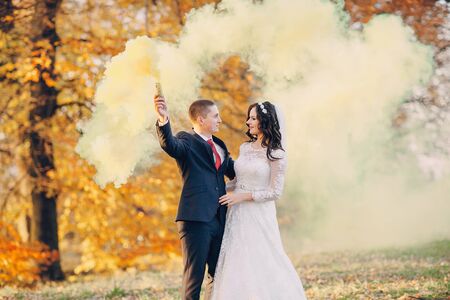 beautiful wedding couple celebrating their wedding day in autumnの写真素材