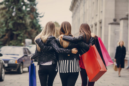 woman with returns from shopping with colored bags fashionの写真素材