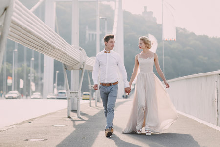 gorgeous wedding couple walking in the old city of Budapestの写真素材
