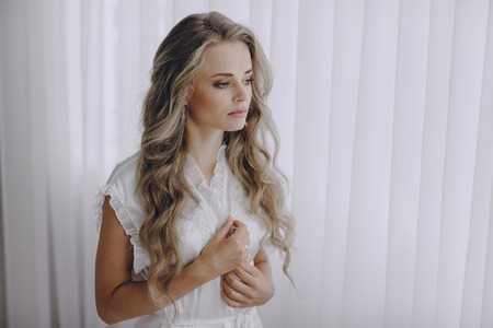 beautiful blonde bride preparing for her weddingの写真素材