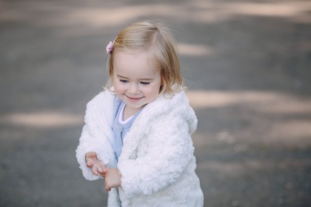 great trendy young mothers walking in the park with his daughters in beautiful clothingの写真素材