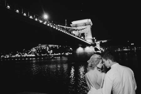 gorgeous wedding couple walking in Budapest at nightの写真素材