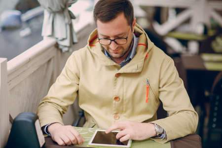 adult man speaks on the phone and writing textの写真素材