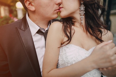 gorgeous wedding couple enjoys a Sunny day in the old town with architectureの写真素材