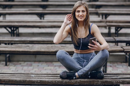 athletic girl running in the Park and doing exercises Joggingの写真素材