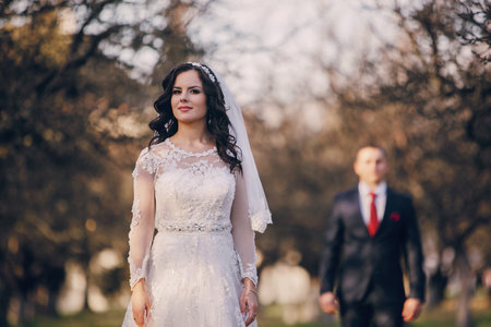 beautiful wedding couple celebrating their wedding day in autumn