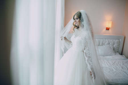 beautiful blonde bride enjoys her wedding day in the summerの写真素材