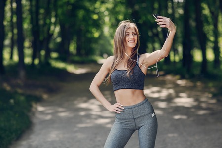 athletic girl running in the Park and doing exercises Joggingの写真素材