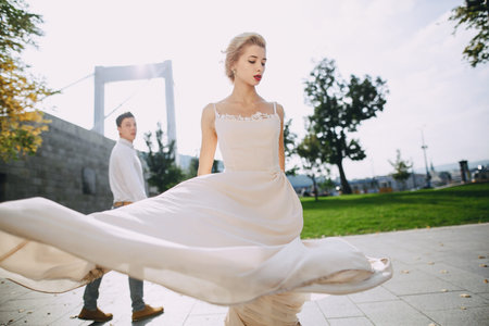 gorgeous wedding couple walking in the old city of Budapestの写真素材