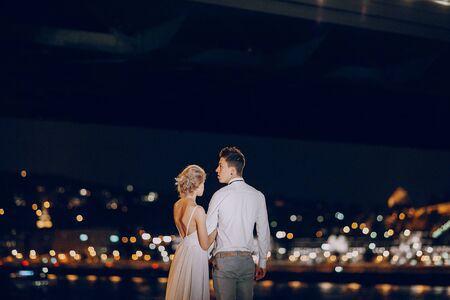 gorgeous wedding couple walking in Budapest at nightの写真素材