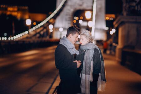 gorgeous wedding couple walking in Budapest at nightの写真素材