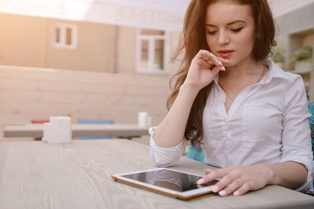 young beautiful business woman spends time alone with her gadgets and solve business issuesの写真素材