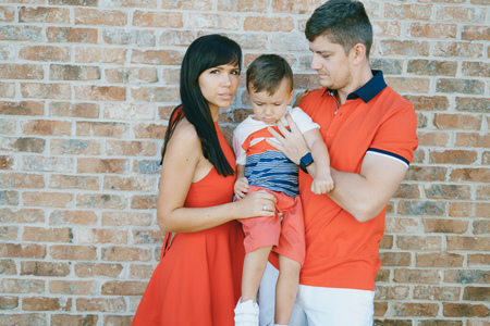 beautiful family in red walking down the street and the Parkの写真素材