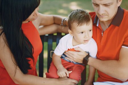 beautiful family in red walking down the street and the Parkの写真素材