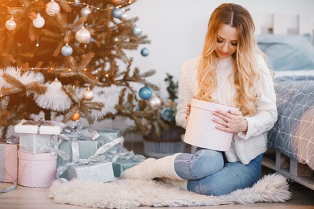 pretty blonde woman opening presentsの写真素材
