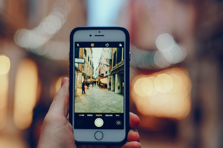 girl talking on the phone and taking pictures in Veniceの写真素材