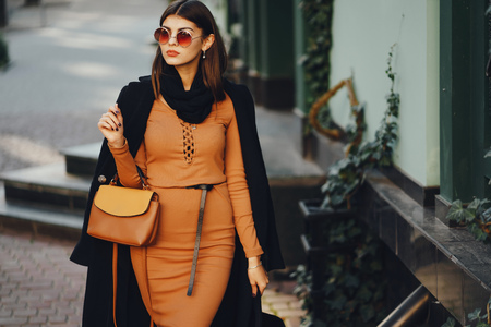 stylish girl walking through the cityの写真素材