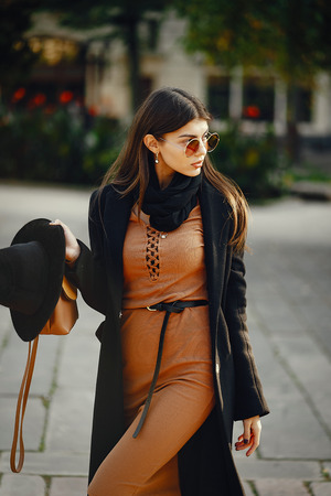 stylish girl walking through the cityの写真素材
