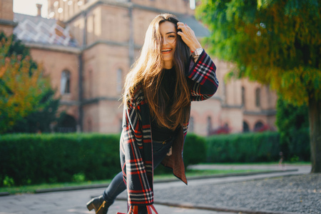 stylish girl walking through the cityの写真素材