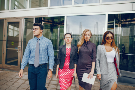 businessman in a summer city with three womenの写真素材