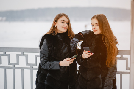 Girls in a winter parkの写真素材