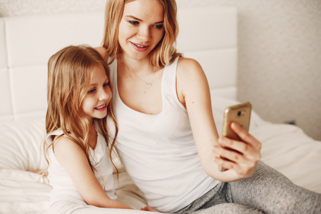 mother with cute blond daughterの写真素材