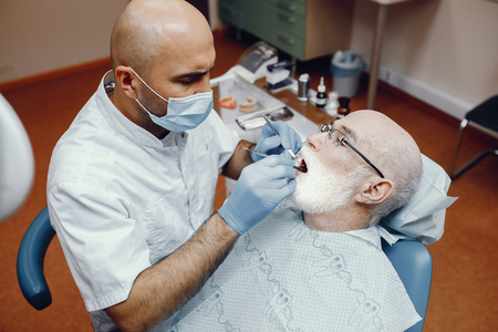 Old man sitting in the dentists officeの写真素材