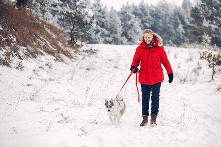 Beautiful woman playing with a dogの写真素材