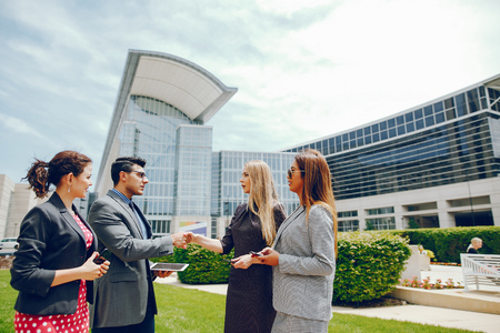businessman in a summer city with three womenの写真素材