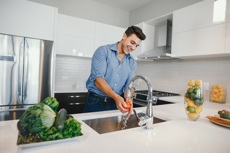 handsome man in a kitchenの写真素材