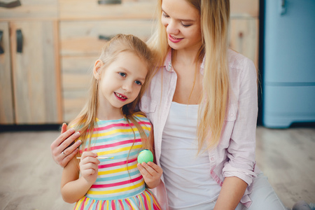 Mother with little daughter in a kitchenの写真素材