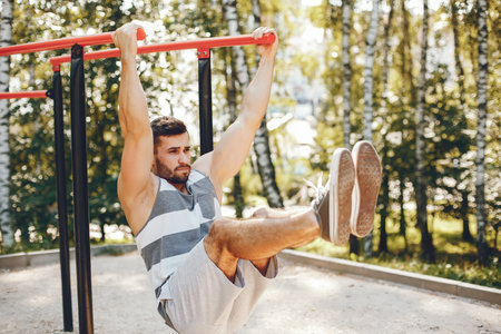 Sports man in a morning summer park