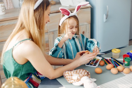 Mother with little daughter in a kitchenの写真素材