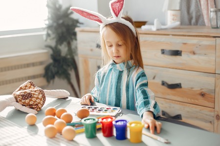 Little girl sitting in a kitchenの写真素材