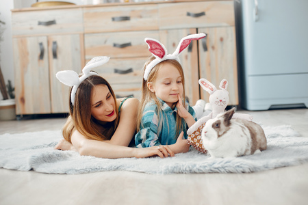 Mother with little daughter in a roomの写真素材