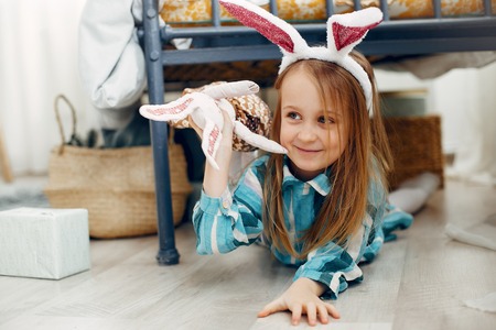 Cute little girl sitting at homeの写真素材