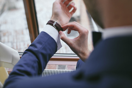 elegant groom in a hotel roomの写真素材