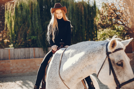 Elegants girl with a horse in a ranchの写真素材
