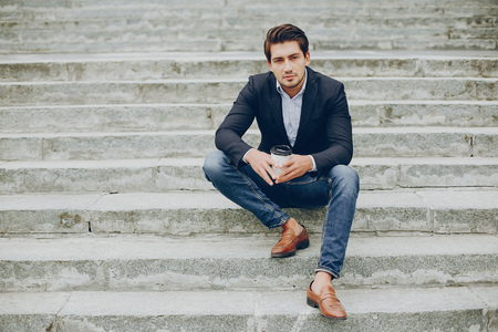 Handsome businesman in a summer cityの写真素材