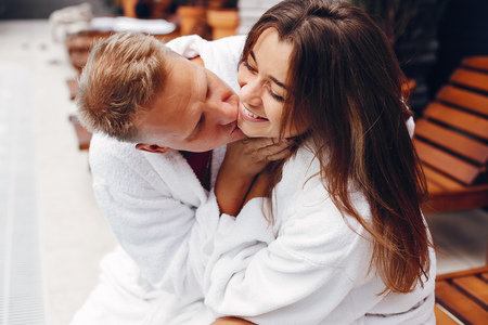 Elegant couple sitting near a swimmingpoolの写真素材