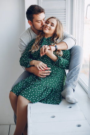 Elegant couple sitting in a studioの写真素材