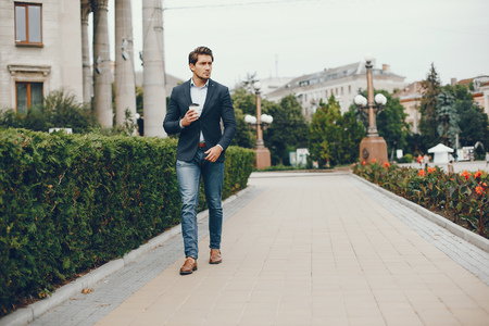Handsome businesman in a summer cityの写真素材