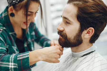 Stylish man sitting in a barbershopの写真素材