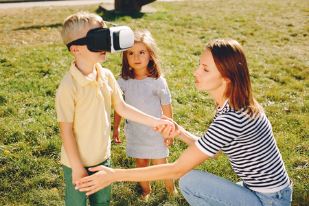 Mother with son playing in a summer parkの写真素材