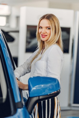 Stylish and elegant woman in a car salonの写真素材