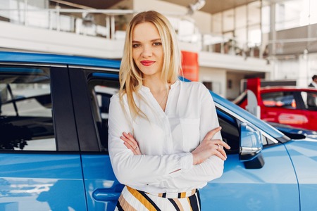 Stylish and elegant woman in a car salonの写真素材