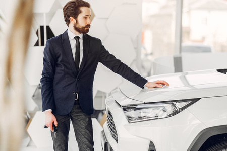 Handsome and elegant man in a car salonの写真素材