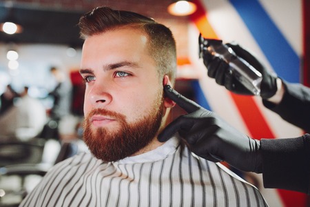 Stylish man sitting in a barbershopの写真素材